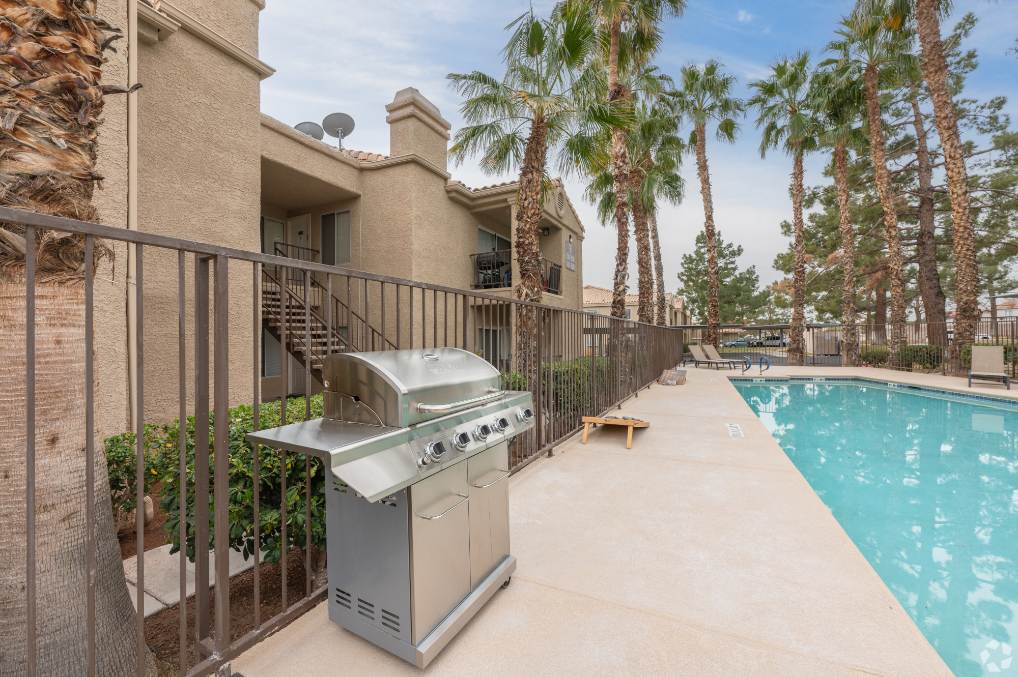 Pines Apartments community pool, lounge area, and grill, Exterior